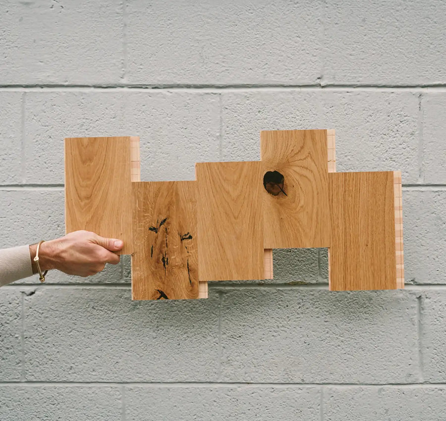 Person holding 5 wood flooring samples that show variation from plank to plank