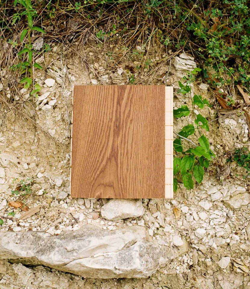 Brown matte wide plank wood floor sample on a limestone ledge