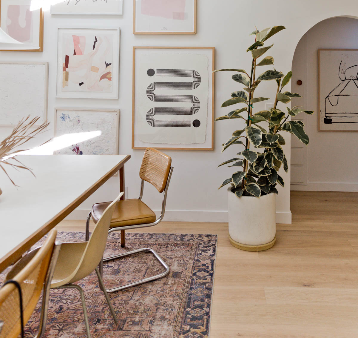 Blonde hardwood floor in a midcentury dining room