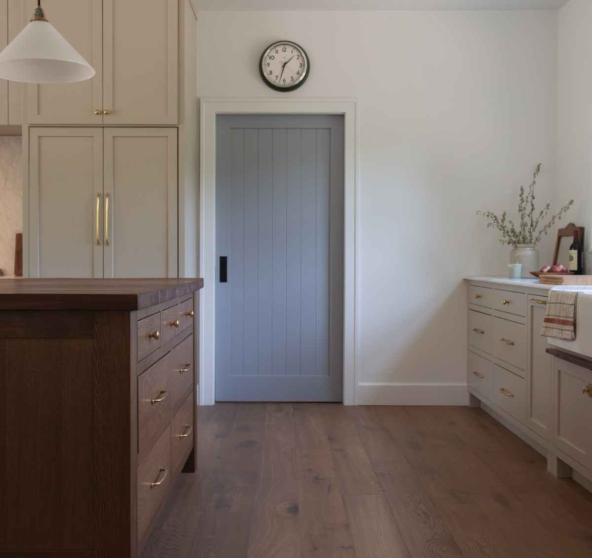 European farmhouse style kitchen with hand-scraped brown hardwood floors