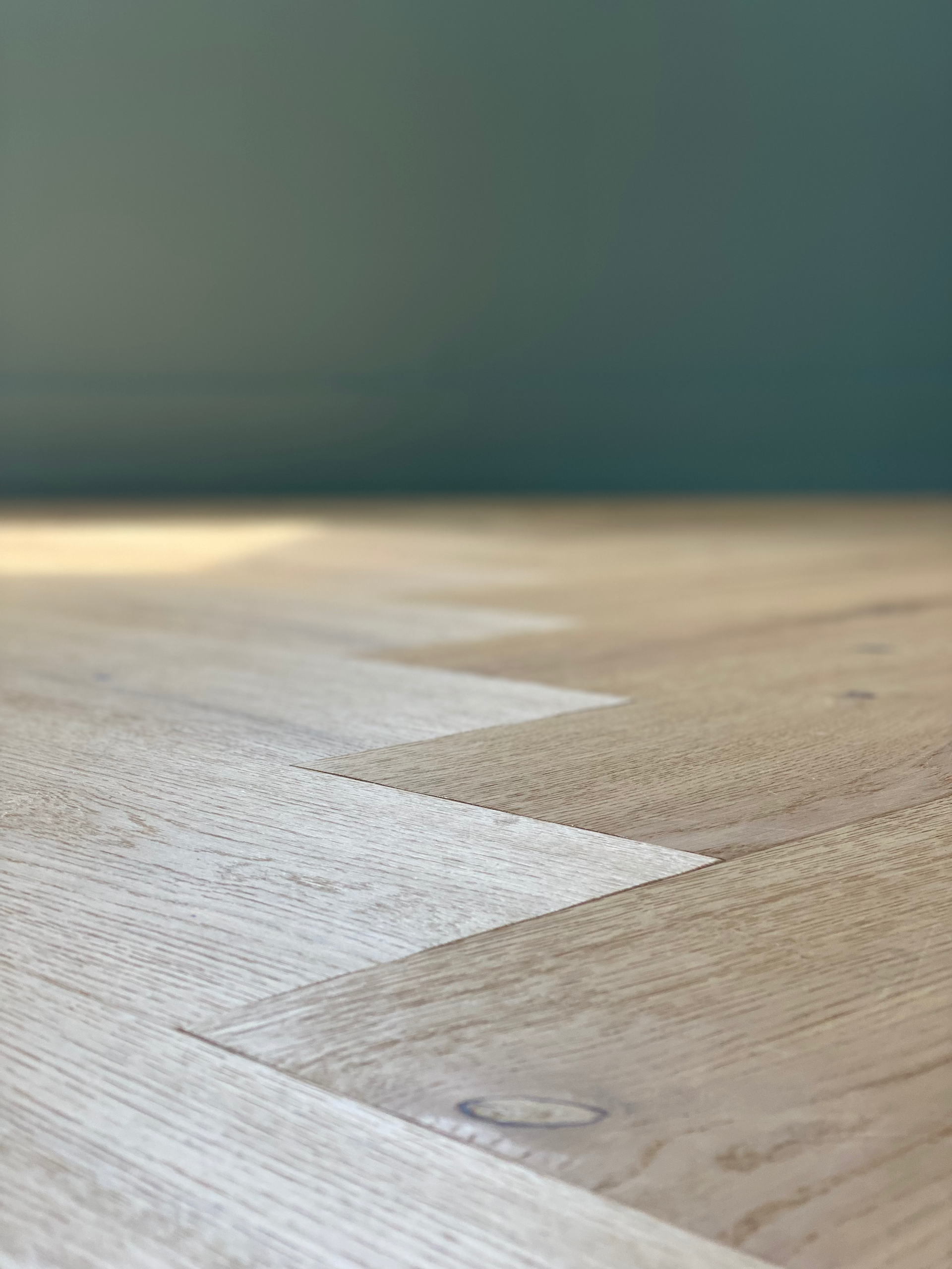 A herringbone white oak wood floor