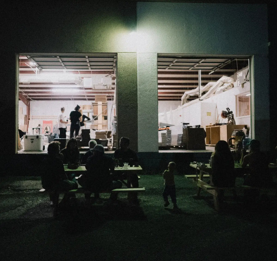 People eating outside the Stuga sample shop in Austin, TX at night
