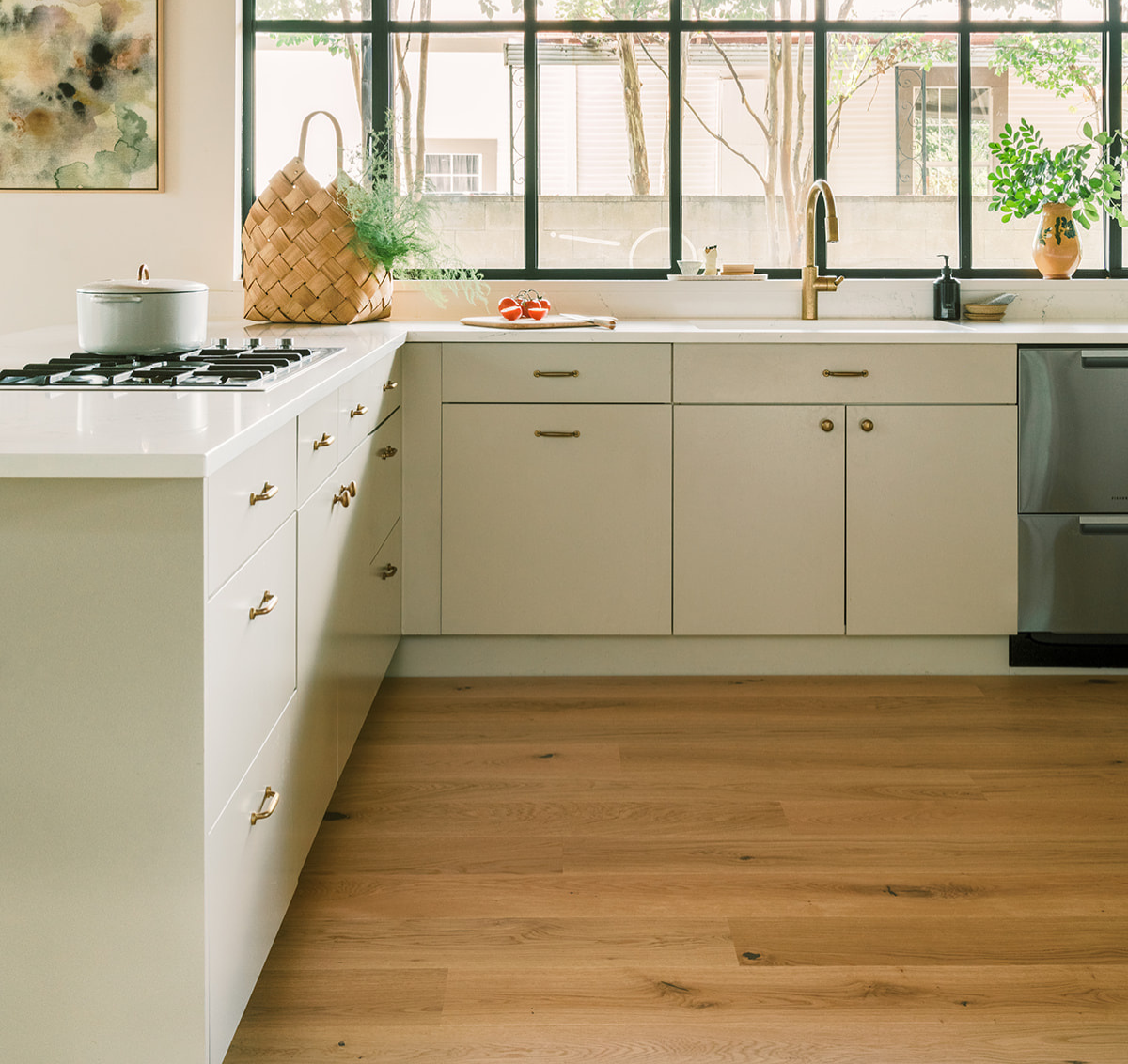 Scandinavian wood flooring in a modern kitchen with gray cabinets