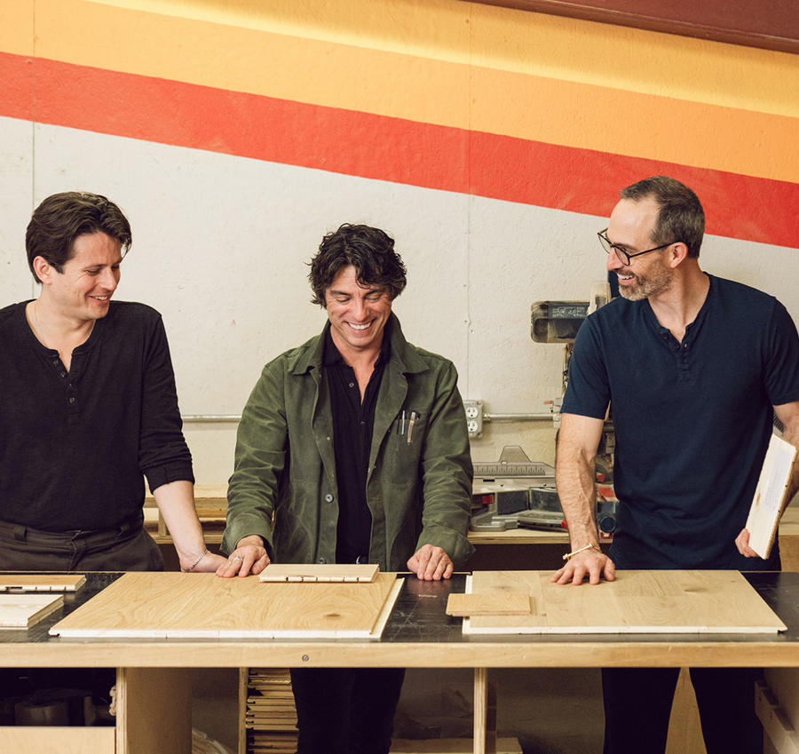 Stuga employees look at hardwood flooring samples in the Austin, Texas sample shop