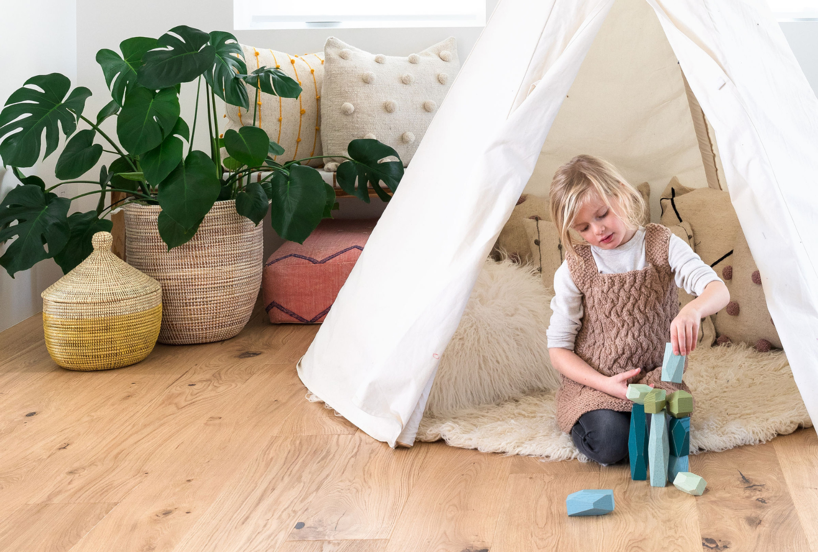 Child playing with blocks on nontoxic hardwood flooring