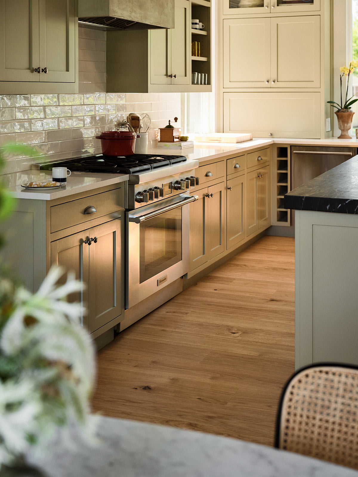 Modern farmhouse kitchen with stainless steel appliances and engineered wood flooring