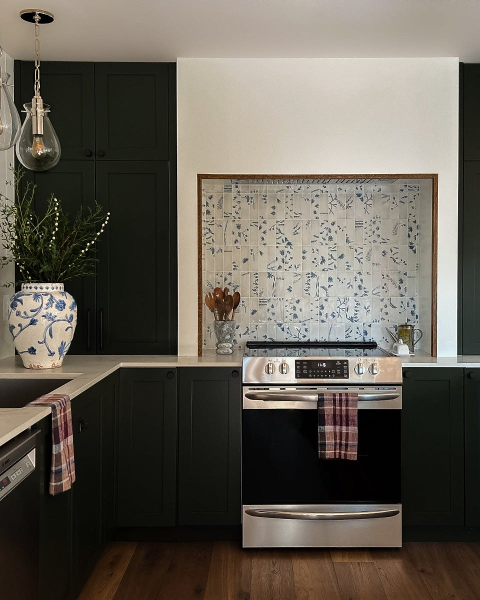 Harbor hand scraped wood flooring by Stuga in a kitchen with painted blue and white tile backsplash