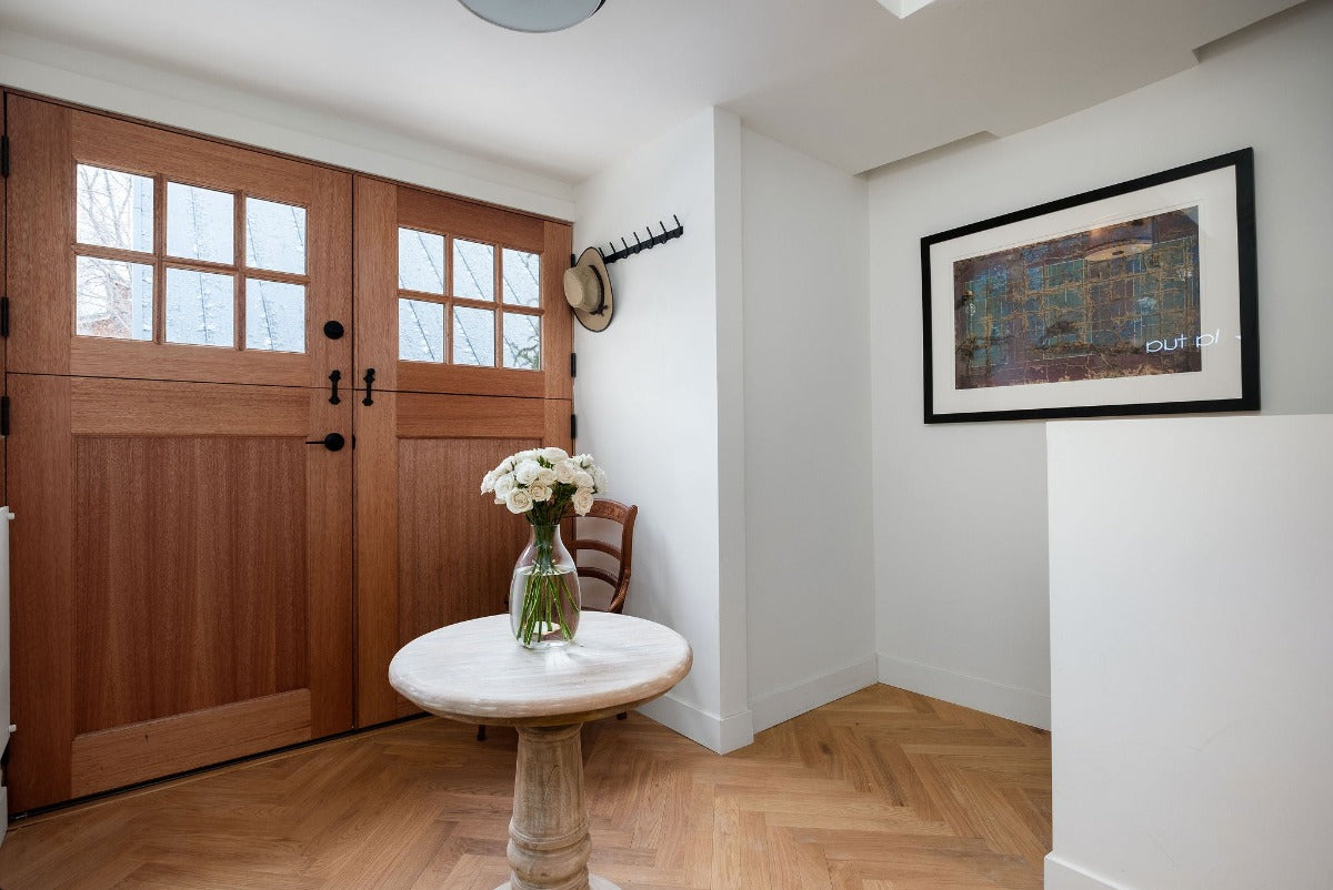 Herringbone wood flooring by Stuga laid in an entryway.