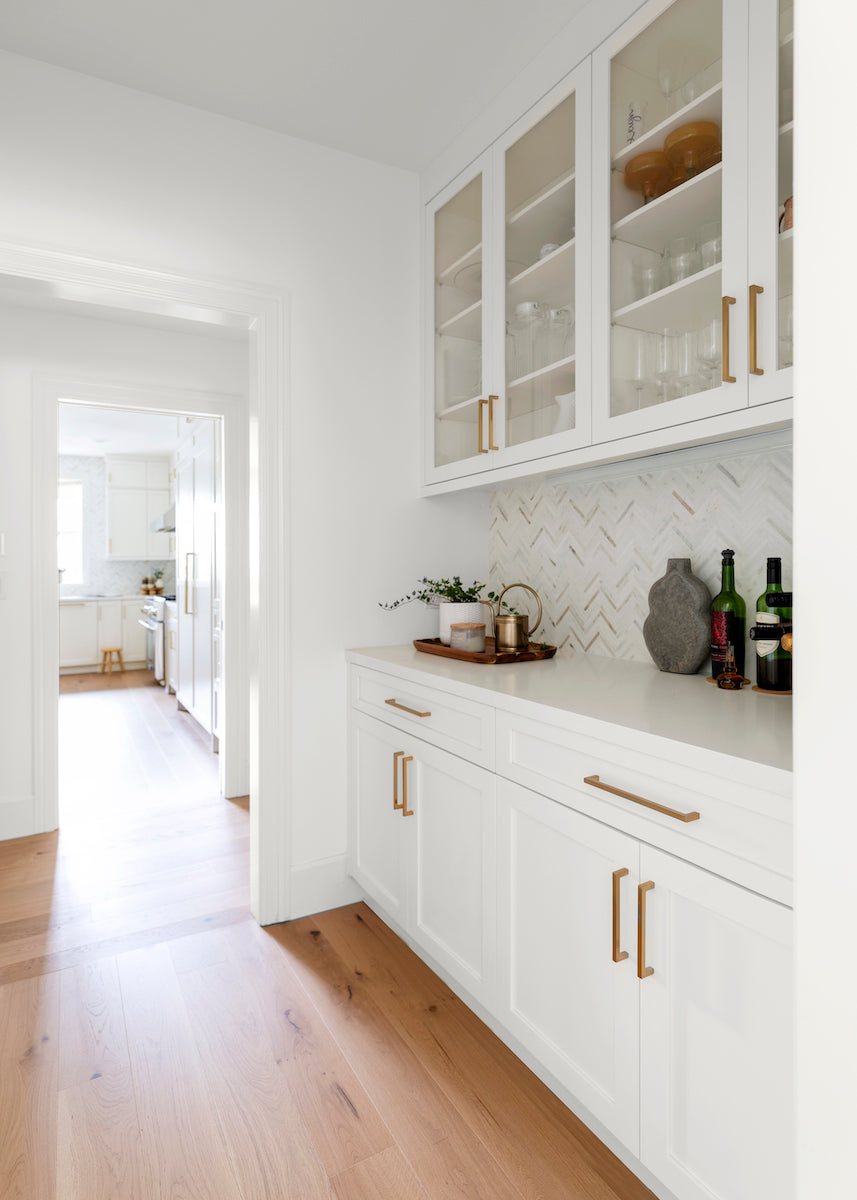 Faye flooring by Chris Loves Julia for Stuga in a white butler's pantry with clear glass cabinets