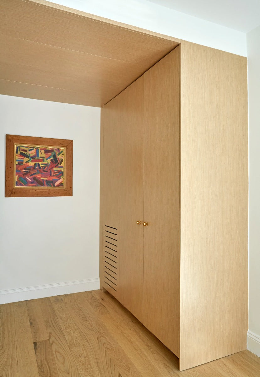 Modern white oak flooring with matching cabinetry in a modern home