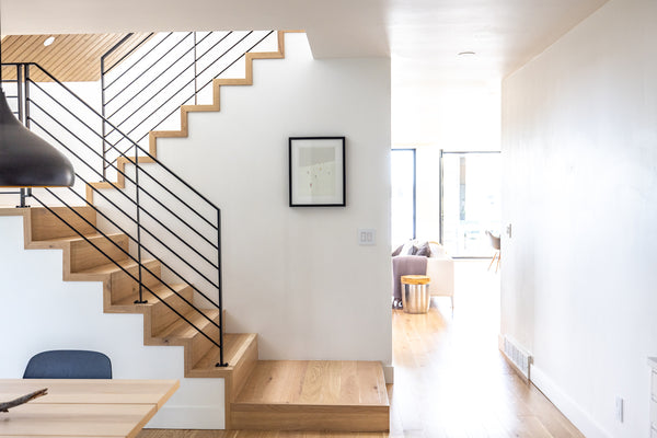 Modern blonde hardwood flooring by Stuga with flush stair nosings and edge caps