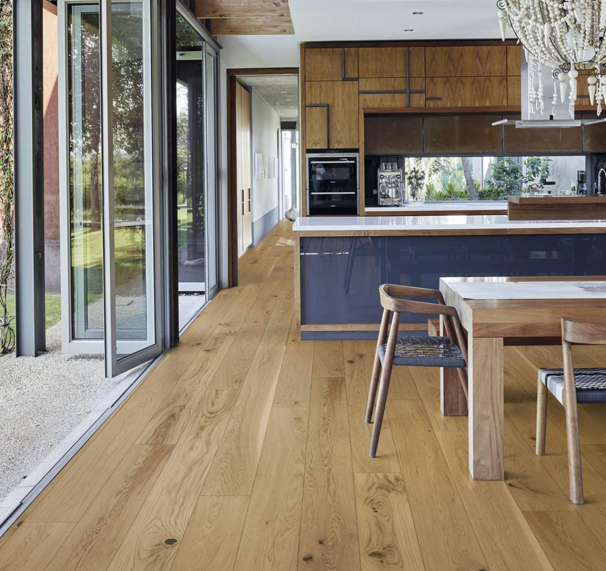Chris Love Julia Faye Stuga Hardwood Flooring featured in kitchen. Blonde oak hardwood wood flooring.