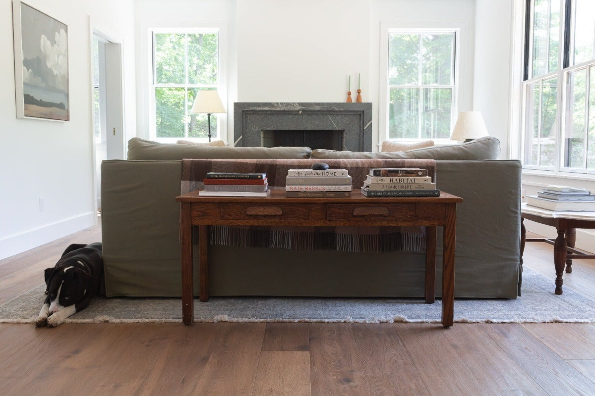 Dog in a European farmhouse living room with hand scraped Scandinavian hardwood flooring