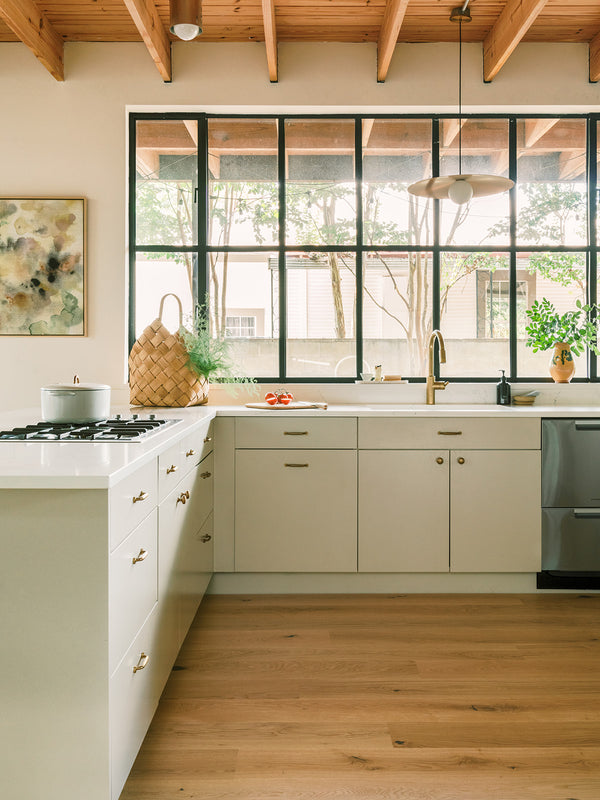 Fredrik neutral white oak flooring in a modern kitchen with light gray cabinets and white counters