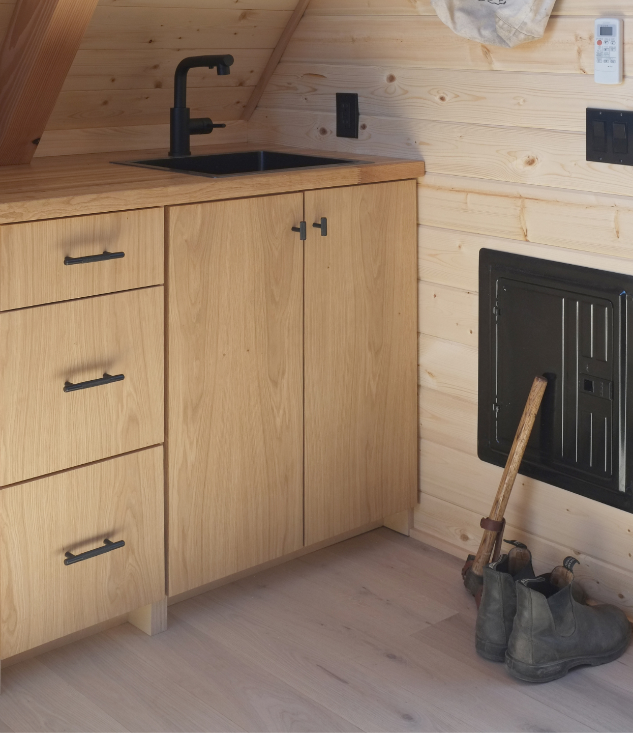 A cabin kitchen with Scandinavian wood flooring and white oak cabinets