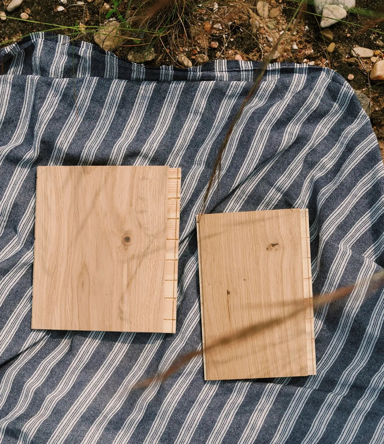 Two wood flooring samples on a striped blanket with labels reading "shell" and "drift"