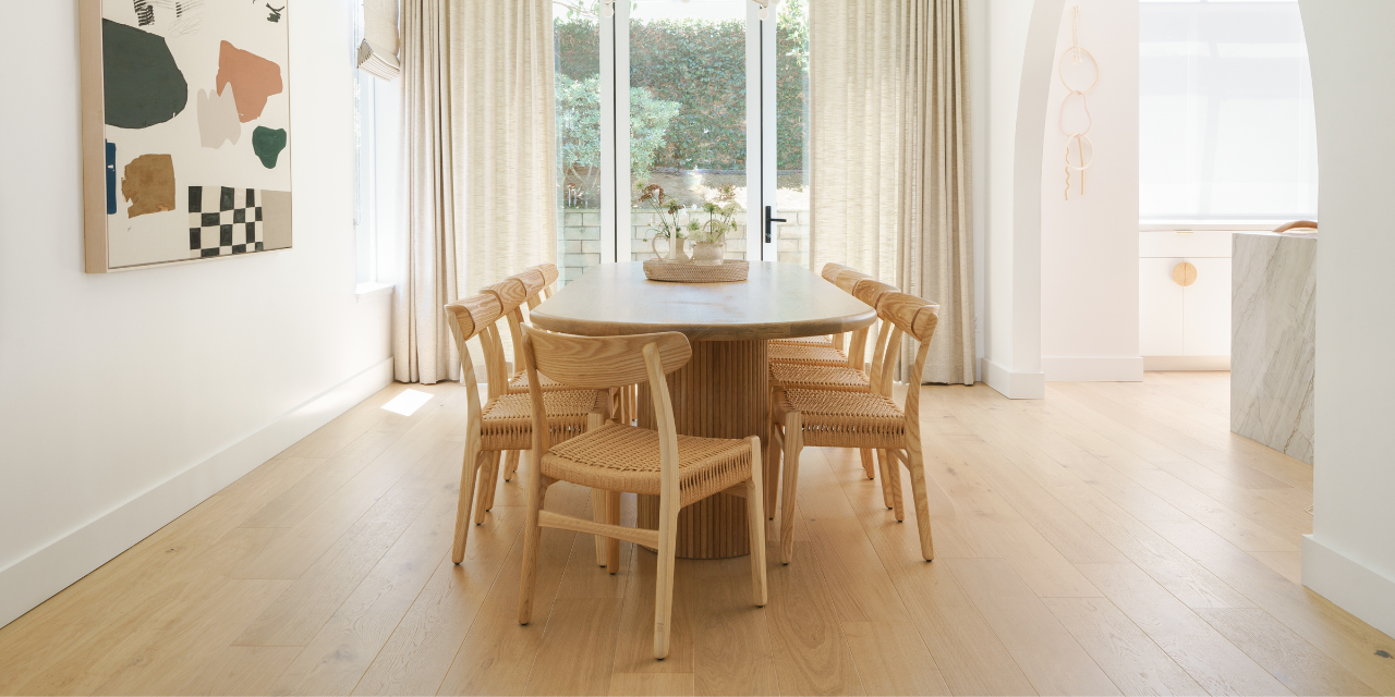 White archway dining room area featuring Stuga Fika Scandinavian wood flooring