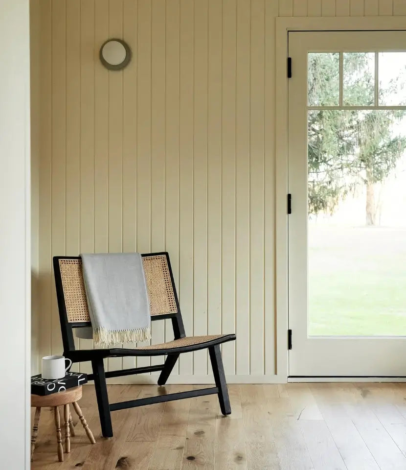 Forest natural oak flooring in a sunroom with a chair and stool