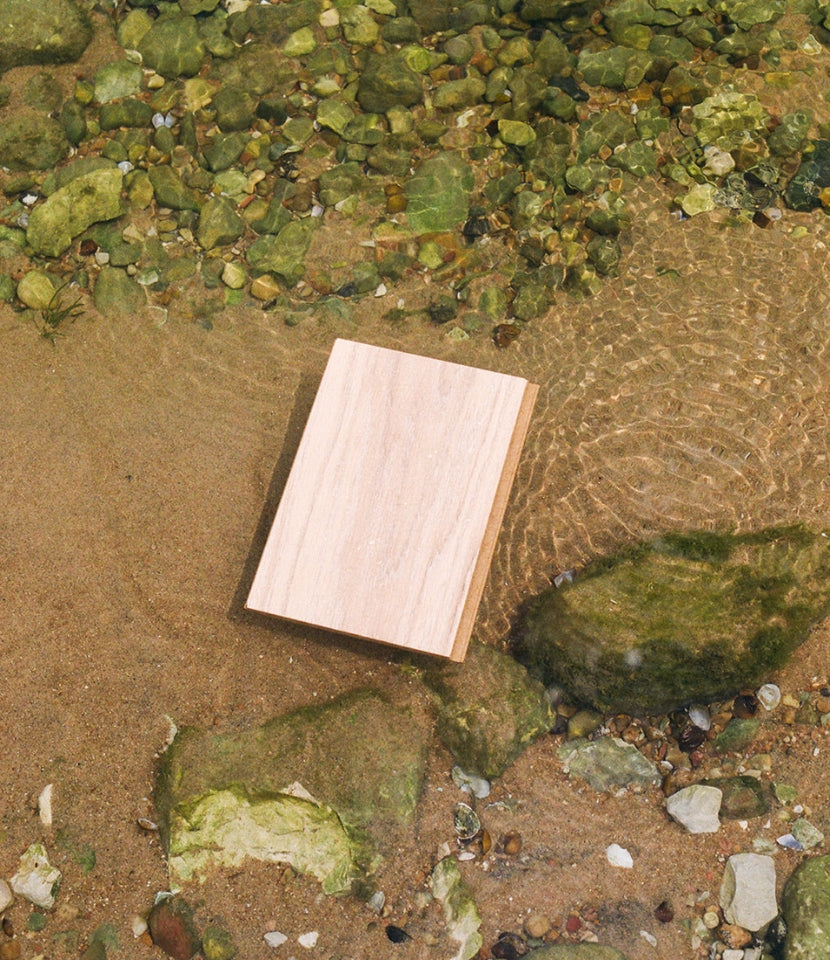 Giddy Up waterproof wood flooring sample in a pool of water