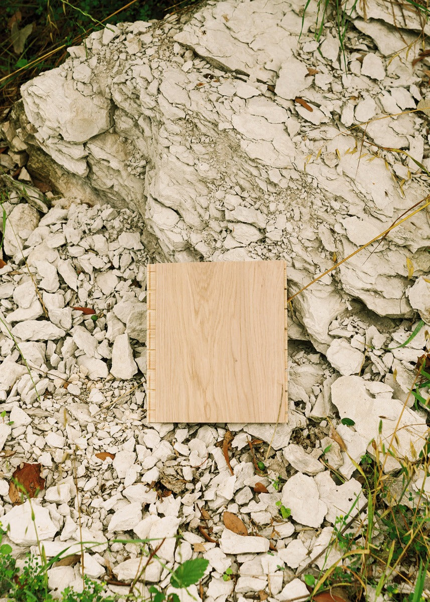 Greta modern white oak flooring sample in a limestone outcropping