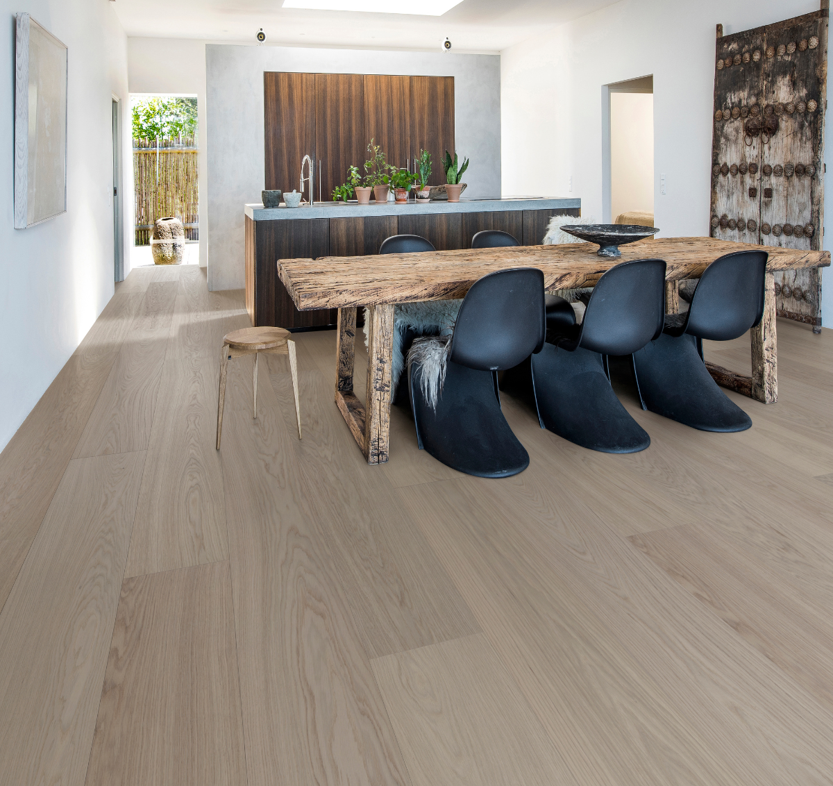 Half Pipe waterproof wood flooring in a living room with Scandinavian chairs and rustic elements