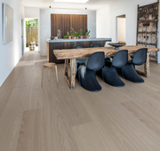 Half Pipe waterproof wood flooring in a living room with Scandinavian chairs and rustic elements