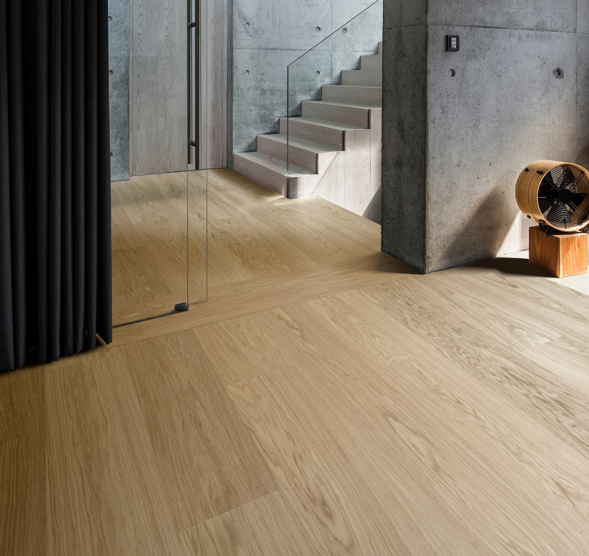 Waterproof wide plank flooring in a hallway with concrete walls and industrial elements