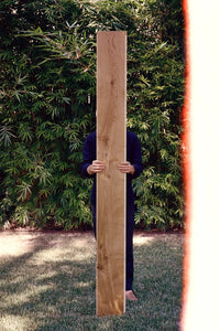 Person holding long plank of engineered hardwood flooring by Stuga