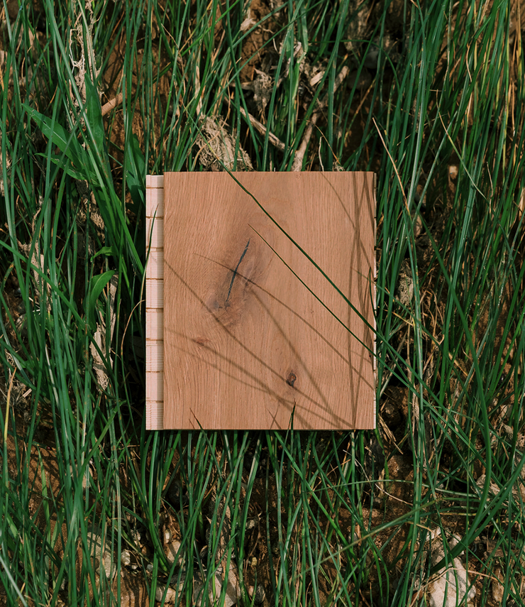 Harbor handscraped wood flooring sample in a bed of grass