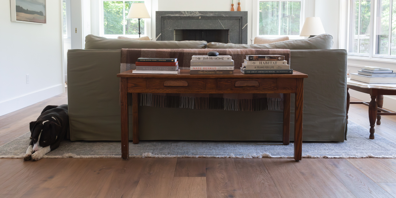 Dog in a European farmhouse living room with hand scraped Scandinavian hardwood flooring