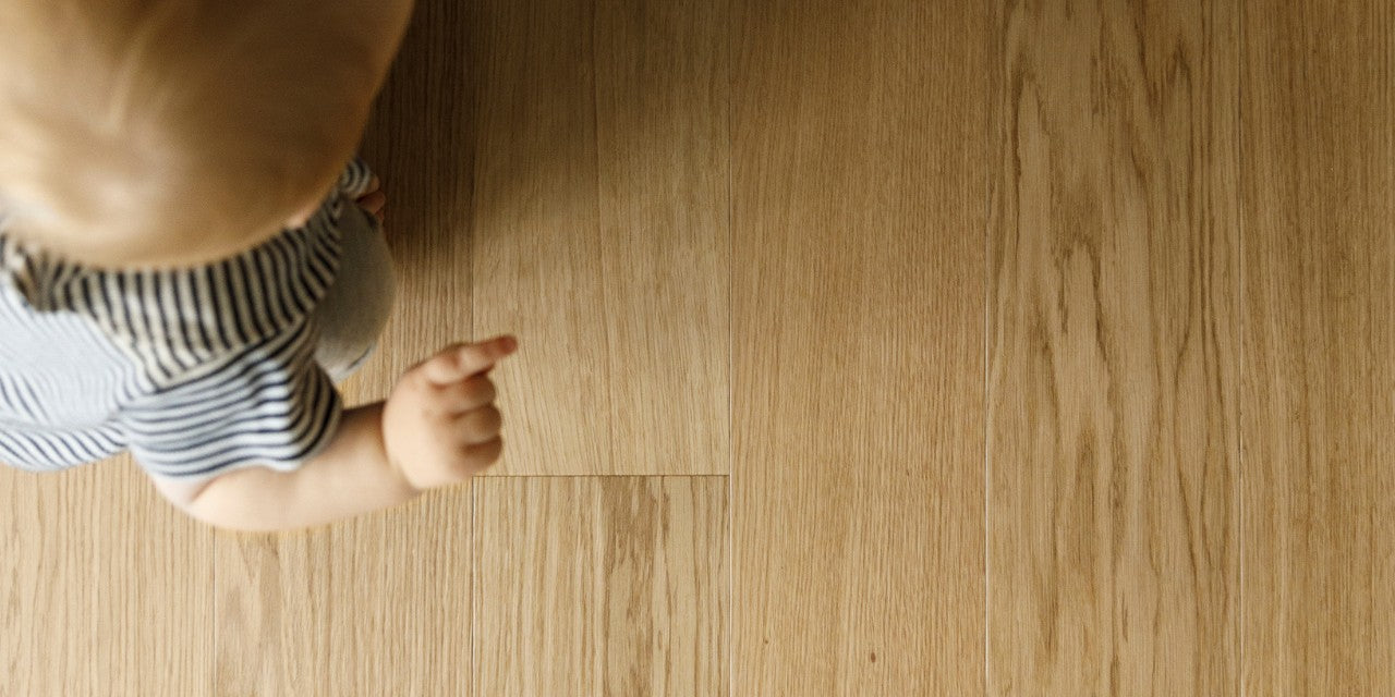 Waterproof wood flooring with a baby playing