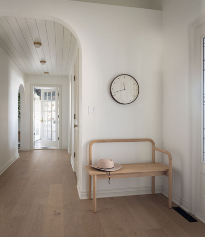 An entryway with a modern bench, paneled ceiling, and Ingrid matte hardwood flooring by Stuga