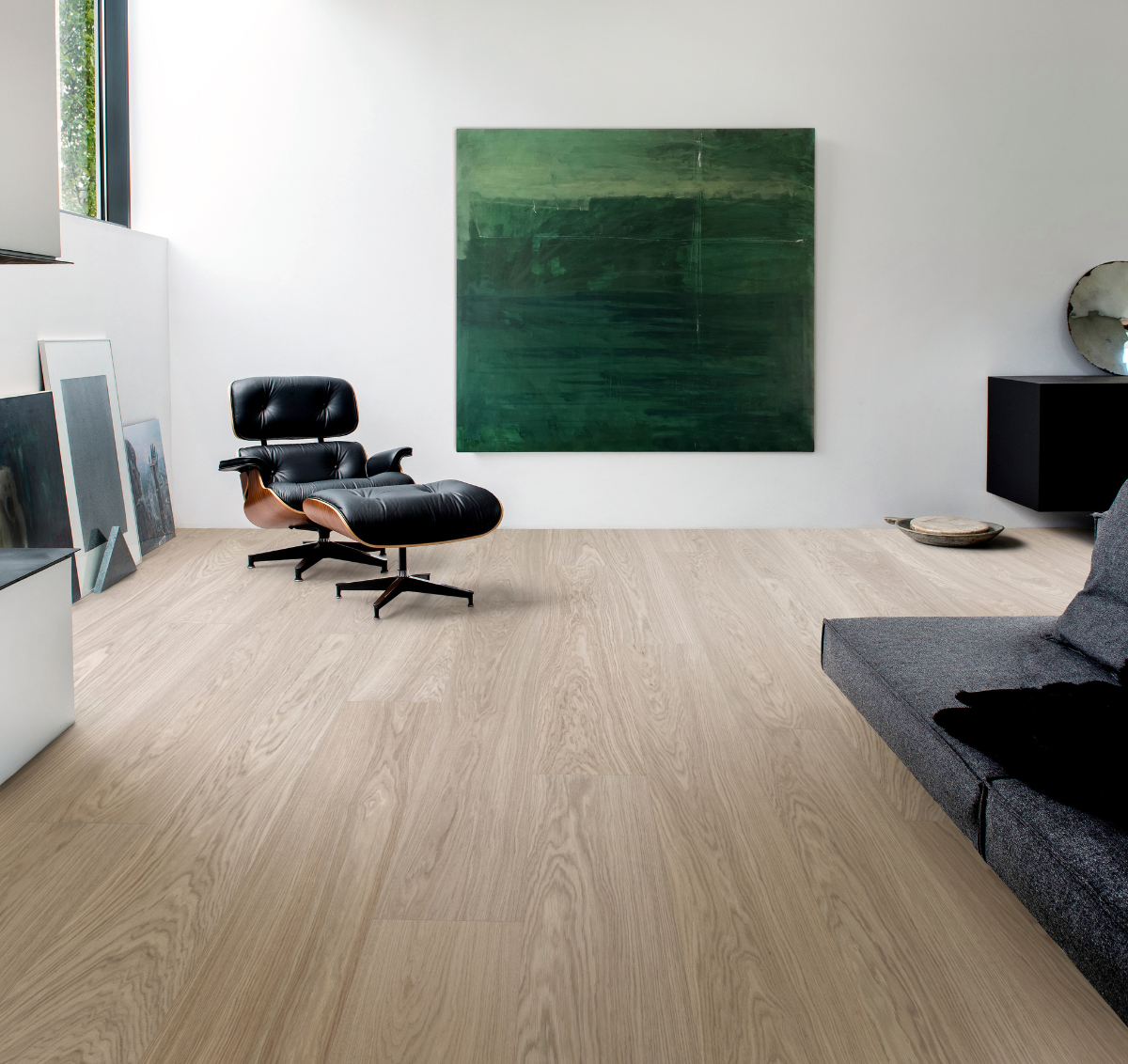 Kickflip waterproof wood flooring in a living room with Eames chair and modern art