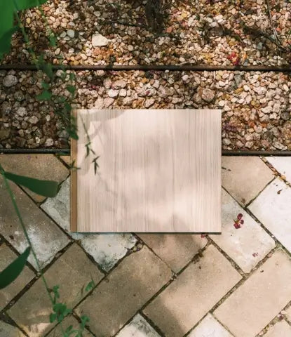 Waterproof wood flooring sample on a herringbone brick patio