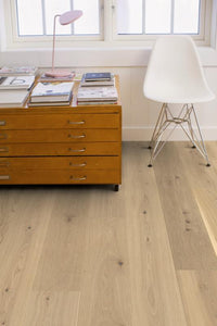 Lucia wide plank warm white oak flooring by Stuga in a bedroom