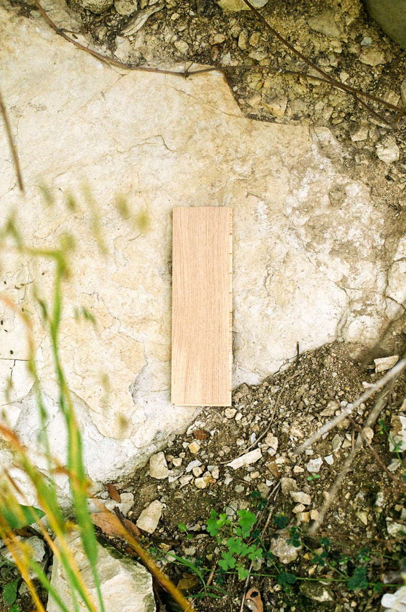 Sisu herringbone wood flooring sample in a limestone outcropping