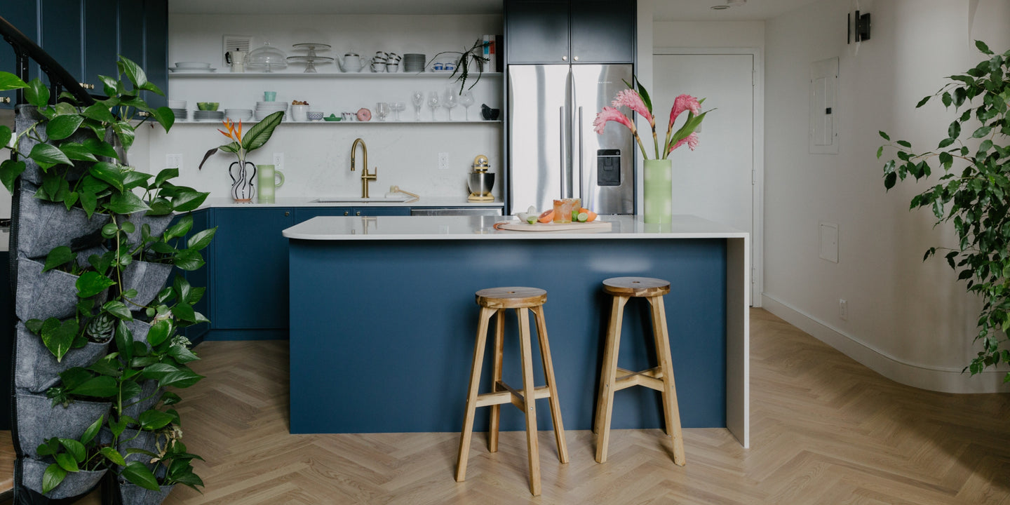 Brownstone Boys kitchen with blue cabinets and Sisu herringbone wood flooring by Stuga