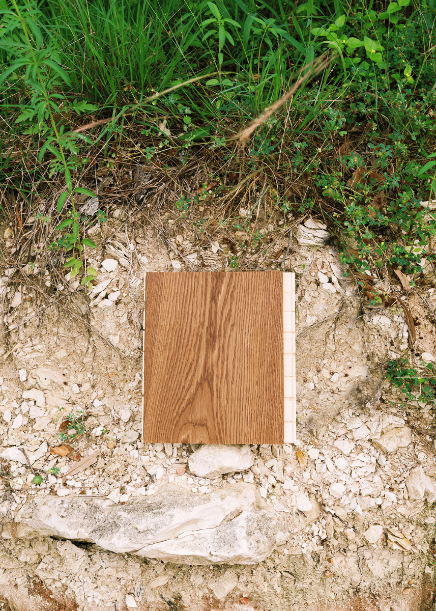 Brown matte wide plank wood floor sample on a limestone ledge