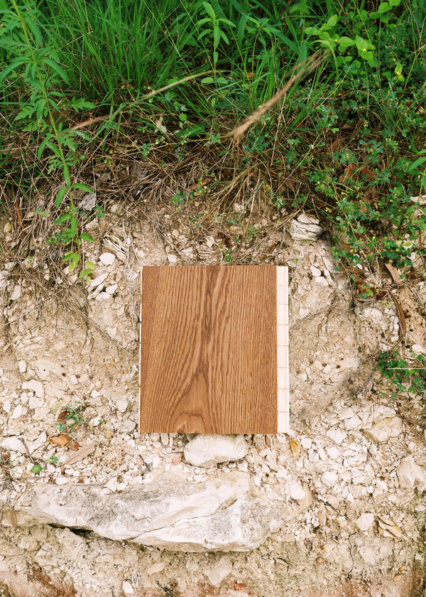 Brown matte wide plank wood floor sample on a limestone ledge