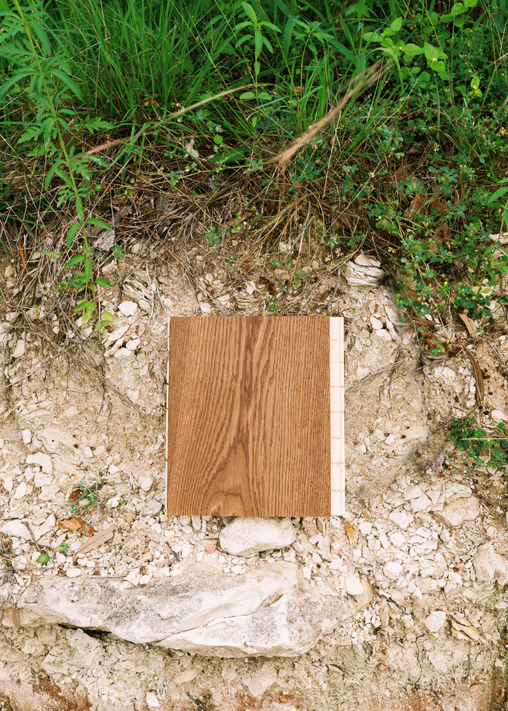 Brown matte wide plank wood floor sample on a limestone ledge