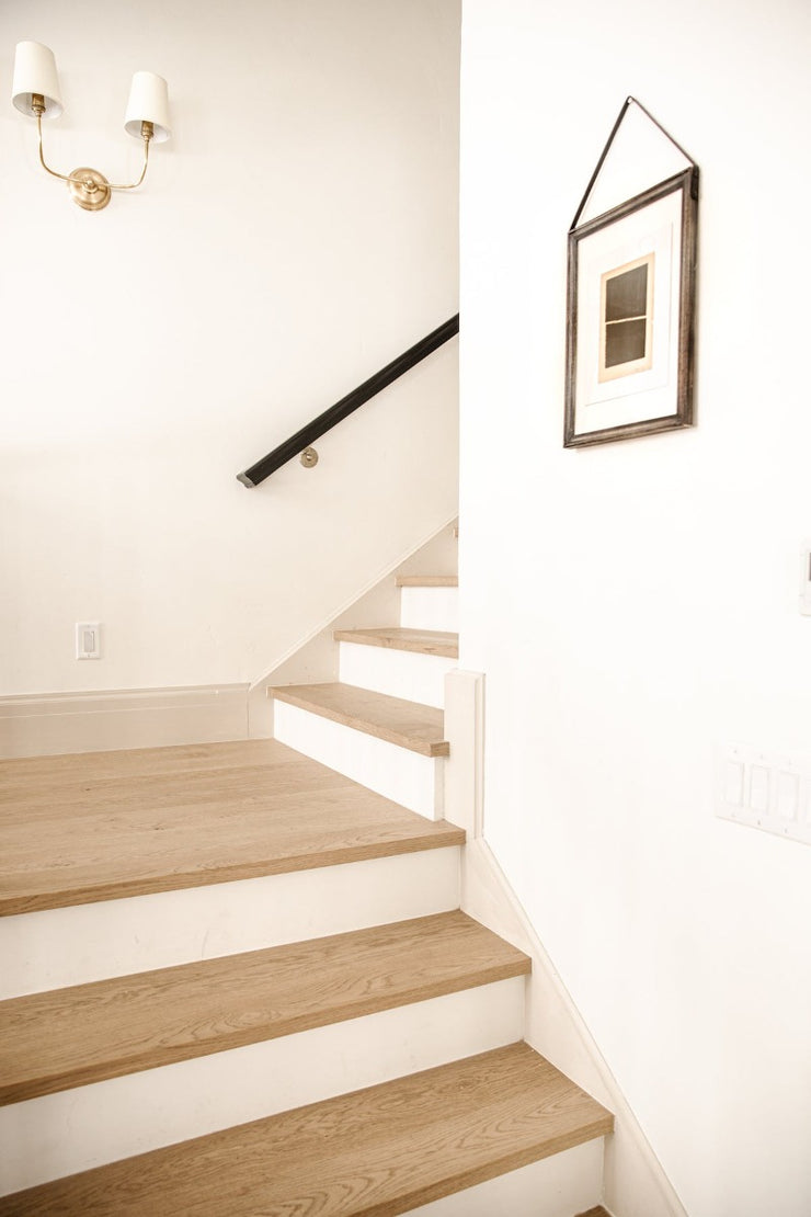 Squared stair nosings with white risers in home of Chris Loves Julia