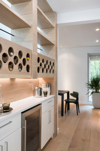 Modern bar area with white oak shelves and engineered hardwood flooring