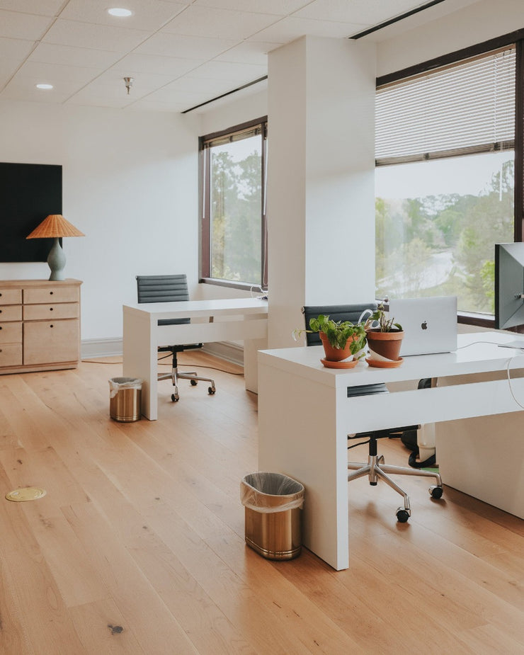The Chris Loves Julia office space with modern desks and hardwood flooring