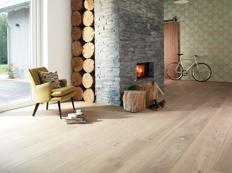 Living room, reading nook, blonde 12 inch wide plank hardwood flooring inspiration photo.