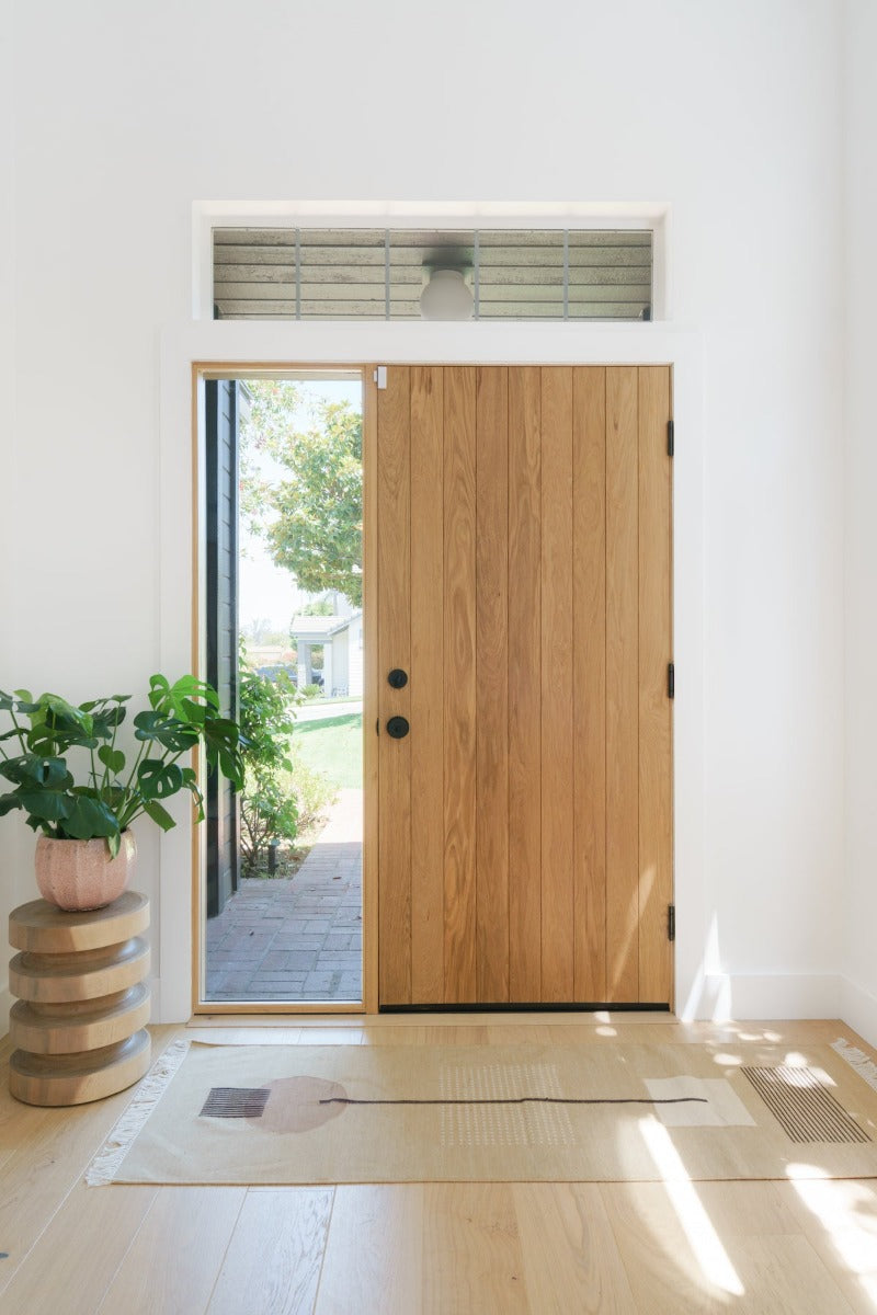 Wood front door entry way featuring Fika Scandinavian white oak flooring