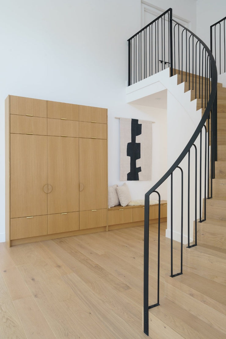 Curved staircase solution featuring Fika hardwood flooring by Stuga