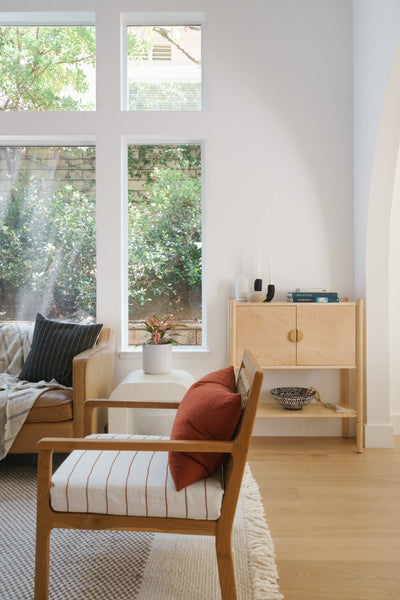 Living room corner with cabinet and chair with Fika hardwood flooring by Stuga