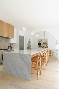 Kitchen renovation inspiration with wood tones cabinets, marble island and Fika Scandinavian hardwood flooring