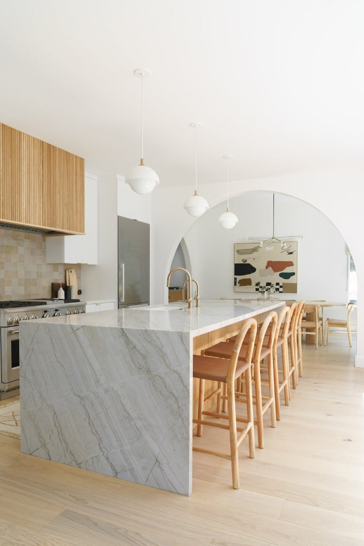 Kitchen renovation inspiration with wood tones cabinets, marble island and Fika Scandinavian hardwood flooring