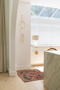 Lovely neutral bedroom nook with white cabinets and natural lighting. Home renovation inspiration featuring Stuga Fika hardwood wood flooring